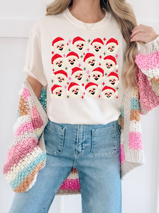 a woman wearing a sweater and a sweater with santa's faces on it
