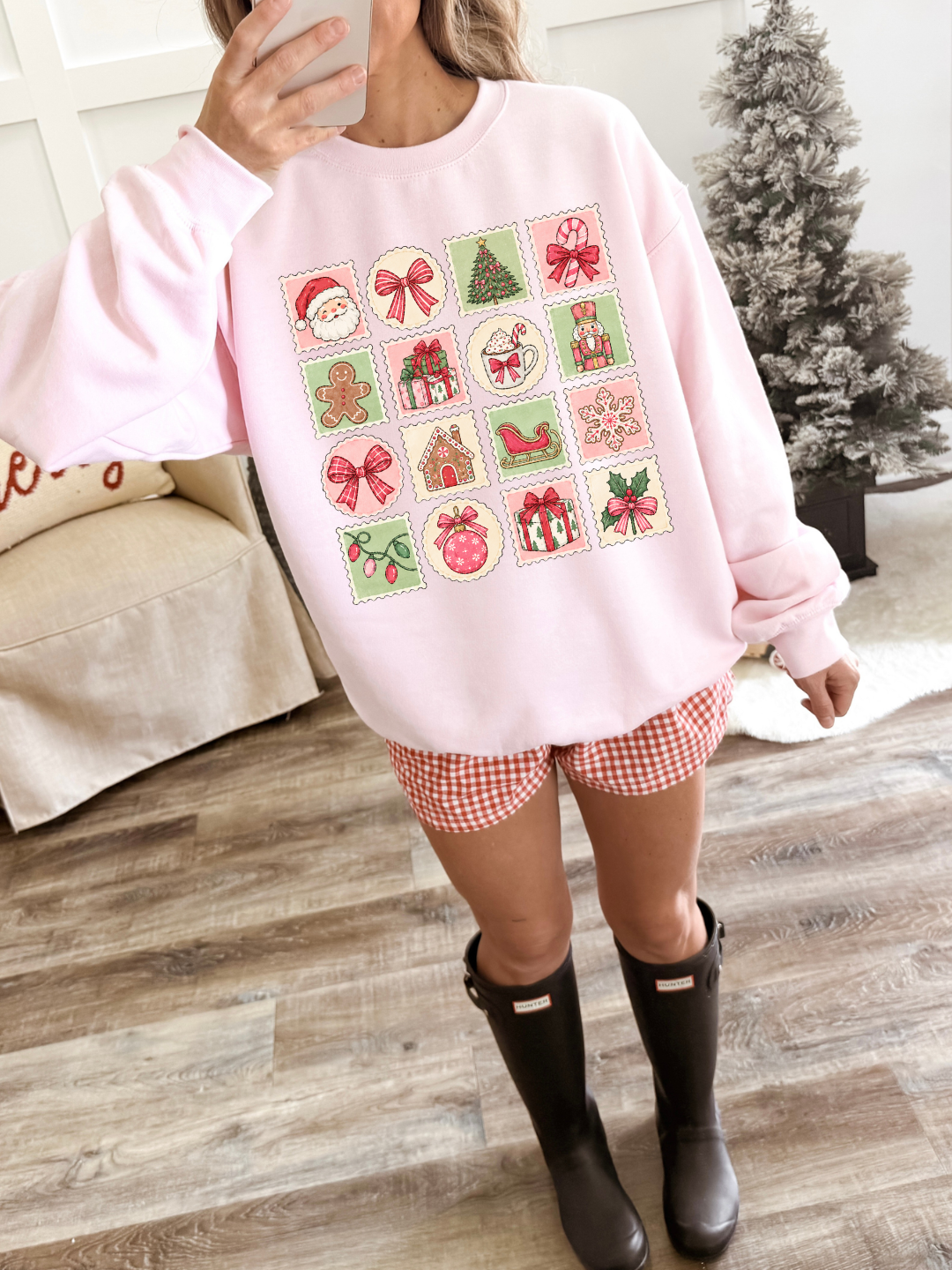 a woman wearing a pink sweater and shorts