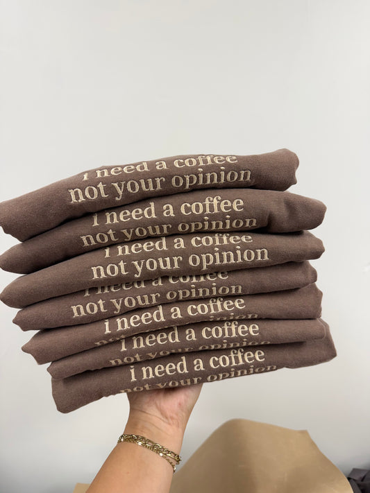 a hand holding a stack of brown cloth with white text